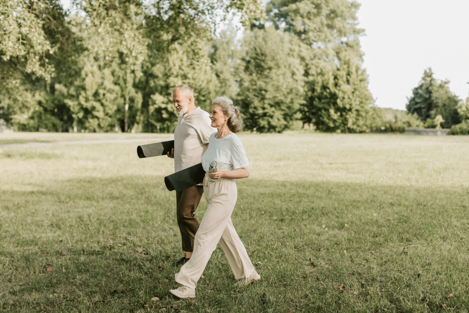Couple walking through a sunlit park